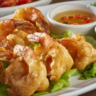 Seven large shrimp, lightly battered in Tempura and then deep fried. Served with sweet ‘n sour sauce, cocktail sauce and comes with two sides.