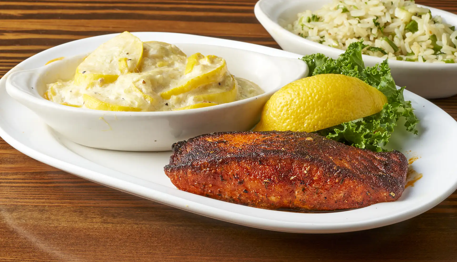 A petite filet of salmon served with two side dishes of your choice. ~Blackened or Charbroiled