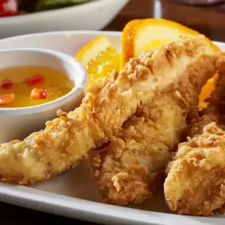 Chicken tenders breaded to the order, served with our sweet and sour sauce and two side dishes of your choice.