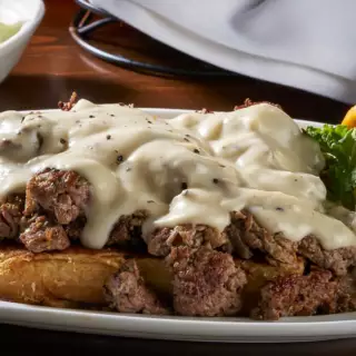 Thinly sliced and grilled Ribeye steak served on Texas Toast and smothered with bacon gravy made from scratch. Served with two sides of your choice.
