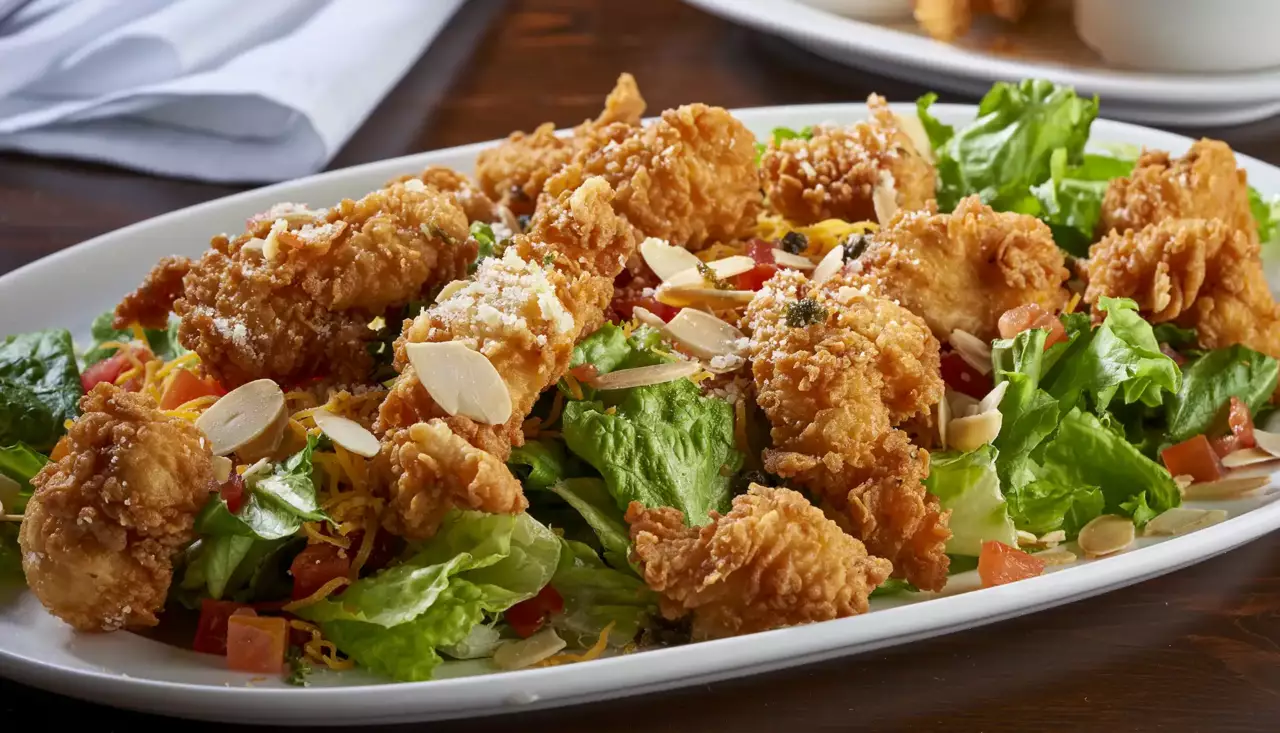 Our fried chicken tenders diced and served on Romaine and green-leaf lettuce, tomatoes, capers, Cheddar cheese, Parmesan cheese and toasted almonds.