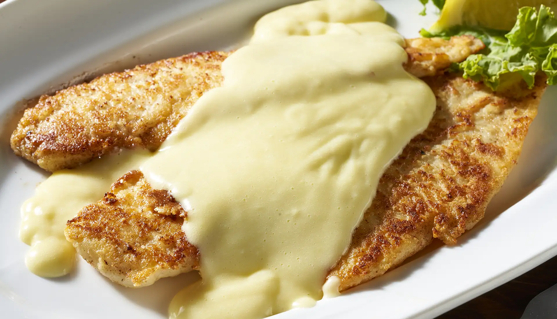 A lightly breaded flounder filet sautéed and served in a lemon-butter sauce with two sides.