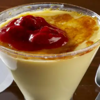 Our version of Crème Brûlée begins with white chocolate custard, we then add a healthy dab of strawberry topping on its caramelized sugar top.