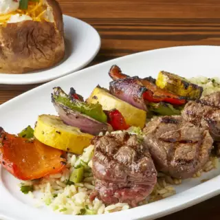 Chunks of heavy aged Filet Mignon, red and green bell peppers, red onions and yellow squash charbroiled to your desired temperature. Served over Gruene rice and a side dish of your choosing.