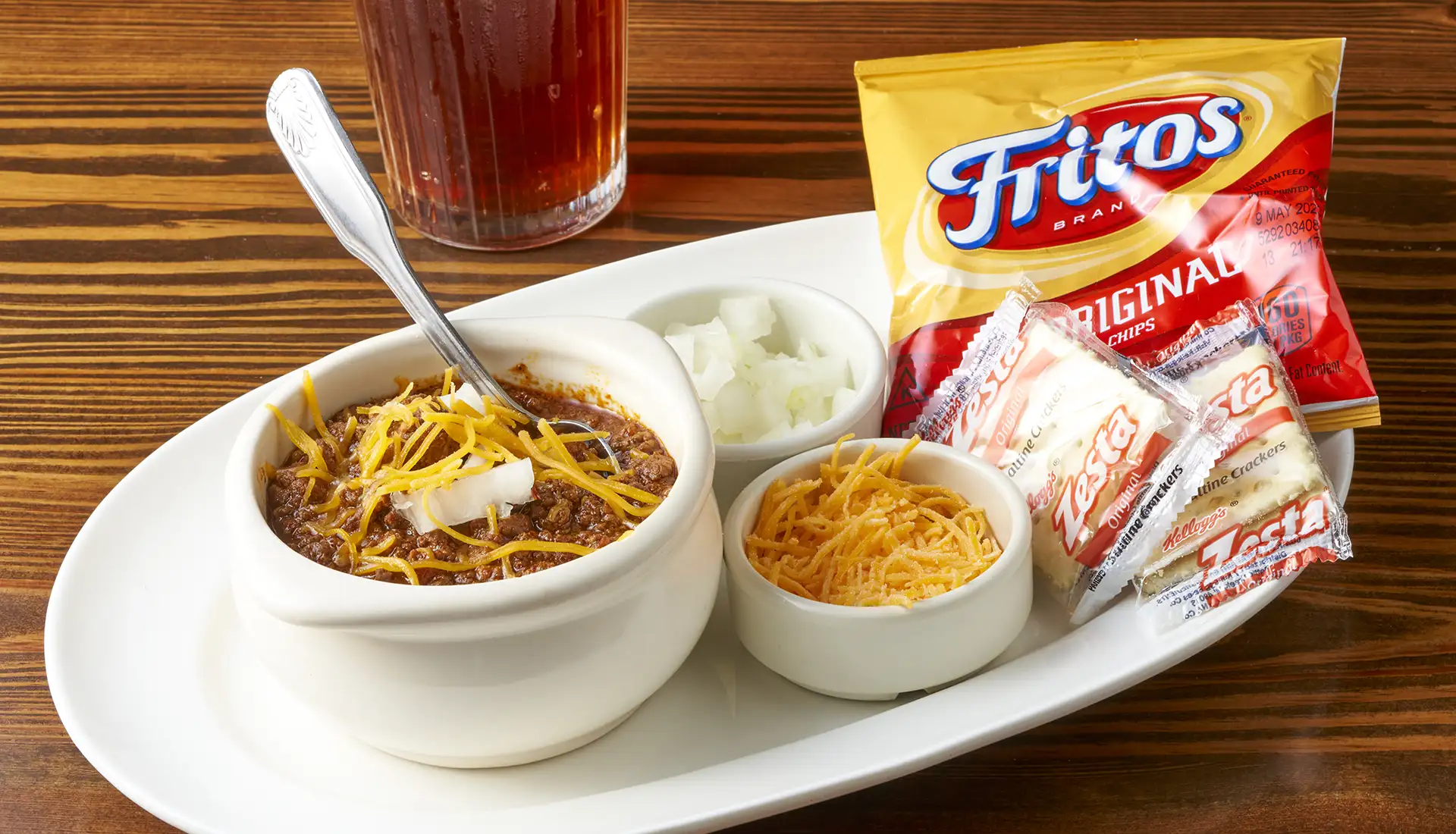 This Texas tradition, made from Goodstock by Nolan Ryan ® Ribeye steak makes this well seasoned homemade chili special. Served with shredded Cheddar cheese, fresh chopped onions, Fritos and crackers.